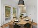Cozy breakfast nook with deck access features a dining table set for four at 52 Ivy Chase Ne, Atlanta, GA 30342