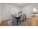 Bright dining room with hardwood floors, seating for six, a classic decor, and a view to the kitchen at 52 Ivy Chase Ne, Atlanta, GA 30342