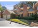 Charming brick townhome featuring a two-car garage and manicured front lawn and a classic brick chimney at 52 Ivy Chase Ne, Atlanta, GA 30342