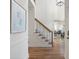Elegant foyer featuring hardwood floors, stairs with iron spindles, and bright natural light and view to living room at 52 Ivy Chase Ne, Atlanta, GA 30342