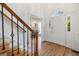 Elegant foyer featuring hardwood floors, stairs with iron spindles, and bright natural light and view to living room at 52 Ivy Chase Ne, Atlanta, GA 30342
