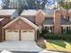 Charming brick home with a two-car garage and well-maintained landscaping at 52 Ivy Chase Ne, Atlanta, GA 30342