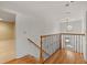 Upper level hallway featuring hardwood floors and decorative railings at 52 Ivy Chase Ne, Atlanta, GA 30342