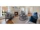 Bright living room features a fireplace, large windows with shutters, hardwood floors, and cozy furniture at 52 Ivy Chase Ne, Atlanta, GA 30342
