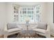 Cozy sitting area featuring bay window with shutter shades, two chairs, and a rattan table at 52 Ivy Chase Ne, Atlanta, GA 30342