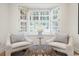Cozy seating area features two armchairs and a window with plantation shutters at 52 Ivy Chase Ne, Atlanta, GA 30342