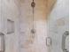 Modern shower featuring neutral tiles, built in niche and glass doors at 52 Ivy Chase Ne, Atlanta, GA 30342