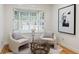 Bright sitting area with hardwood floors and shuttered windows at 52 Ivy Chase Ne, Atlanta, GA 30342