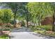 Community street view lined with mature trees and brick homes with attached garages at 52 Ivy Chase Ne, Atlanta, GA 30342