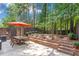 Backyard featuring a patio, dining area, and mature trees at 7524 Portbury Park Ln, Suwanee, GA 30024