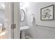 Bathroom with a pedestal sink, neutral walls, and modern fixtures at 7524 Portbury Park Ln, Suwanee, GA 30024