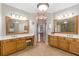 Elegant bathroom with dual vanities, granite countertops, and tile flooring at 7524 Portbury Park Ln, Suwanee, GA 30024