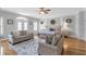 Spacious bedroom featuring a sitting area, French doors, and elegant decor at 7524 Portbury Park Ln, Suwanee, GA 30024
