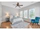 Cozy bedroom with hardwood floors, natural light, and a modern ceiling fan at 7524 Portbury Park Ln, Suwanee, GA 30024