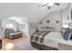 Bedroom featuring hardwood floors, natural light, and a comfortable seating area at 7524 Portbury Park Ln, Suwanee, GA 30024