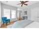 Bedroom featuring three windows that let in light with an accent chair at 7524 Portbury Park Ln, Suwanee, GA 30024