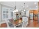 Open floor plan with dining area, white trim, and seamless transition to the living space at 7524 Portbury Park Ln, Suwanee, GA 30024