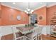 Inviting dining room with warm colors, wainscoting, and stylish decor at 7524 Portbury Park Ln, Suwanee, GA 30024