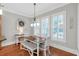Bright dining area features natural light and hardwood flooring at 7524 Portbury Park Ln, Suwanee, GA 30024