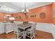 Charming dining room with a large mirror and wainscoting detail at 7524 Portbury Park Ln, Suwanee, GA 30024