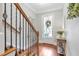 Entryway with hardwood floors, staircase with wrought iron, and natural light at 7524 Portbury Park Ln, Suwanee, GA 30024