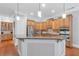 Spacious kitchen island features ample countertop space, stainless steel appliances, and custom cabinetry at 7524 Portbury Park Ln, Suwanee, GA 30024