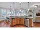 Charming kitchen with a breakfast bar, stainless steel appliances, and hardwood floors at 7524 Portbury Park Ln, Suwanee, GA 30024
