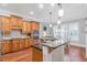 Modern kitchen with stainless steel appliances, granite countertops, and light wood cabinetry at 7524 Portbury Park Ln, Suwanee, GA 30024