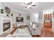 Spacious living room with fireplace, hardwood floors, and neutral color palette at 7524 Portbury Park Ln, Suwanee, GA 30024