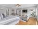 Bright main bedroom with hardwood floors, a sitting area, and plenty of natural light at 7524 Portbury Park Ln, Suwanee, GA 30024