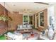 Cozy patio with brick accents, outdoor seating, and a ceiling fan for added comfort at 7524 Portbury Park Ln, Suwanee, GA 30024