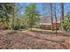 Picturesque backyard featuring a lush lawn, wooden deck, mature trees, and serene natural surroundings at 2447 Caladium Ne Dr, Atlanta, GA 30345