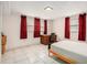 This bedroom has light tile and a desk and curtains for privacy at 2447 Caladium Ne Dr, Atlanta, GA 30345