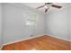 This bedroom has natural light and is complemented by wood floors and a ceiling fan at 2447 Caladium Ne Dr, Atlanta, GA 30345