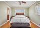 Serene bedroom with hardwood floors, neutral paint, and a large window offering plenty of natural light at 2447 Caladium Ne Dr, Atlanta, GA 30345
