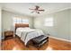 Cozy bedroom boasts natural light, hardwood floors, and a comfortable bed with a padded storage bench at 2447 Caladium Ne Dr, Atlanta, GA 30345
