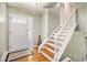 Bright foyer with hardwood floors, a staircase with white railing, and a decorative front door at 2447 Caladium Ne Dr, Atlanta, GA 30345