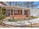 Inviting covered front porch on a charming brick home with a well-lit entryway and walkway at 2447 Caladium Ne Dr, Atlanta, GA 30345
