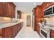 Gourmet kitchen with custom wood cabinets, stainless steel appliances, granite countertops, and tiled floors at 2447 Caladium Ne Dr, Atlanta, GA 30345