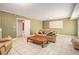 Comfortable living room with tile floors, a plush sofa, and access to other rooms of the house at 2447 Caladium Ne Dr, Atlanta, GA 30345