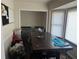 Dual purpose room with a dark wood table, laundry baskets, a black and white board and washer and dryer in background at 7977 Woods Ln, Jonesboro, GA 30236