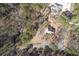 Aerial view of house with private pool surrounded by mature trees on a wooded lot at 2012 Trade Winds Dr, Canton, GA 30115