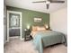 Bedroom features a green accent wall, ceiling fan, and ensuite bathroom, offering a private retreat at 2106 Sycamore Ln, Loganville, GA 30052
