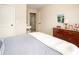 Bedroom showcasing a warm color palette, including a wooden dresser and carpeted flooring at 2106 Sycamore Ln, Loganville, GA 30052