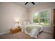 Cozy bedroom with a comfortable bed, large window, and neutral decor at 2106 Sycamore Ln, Loganville, GA 30052