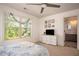 Bright bedroom with a ceiling fan, large window overlooking nature, and an en-suite bathroom at 2106 Sycamore Ln, Loganville, GA 30052