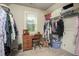 Walk-in closet offers ample storage and organization with clothes racks, shelving, and a vanity area at 2106 Sycamore Ln, Loganville, GA 30052