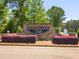 Woodland Hills community entrance sign surrounded by manicured landscaping, creating an inviting and sophisticated entry at 2106 Sycamore Ln, Loganville, GA 30052