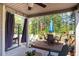 Inviting covered patio features an outdoor dining area, lounge space, and serene view of the wooded backyard at 2106 Sycamore Ln, Loganville, GA 30052