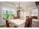 Inviting dining area with a large window, classic chandelier, and comfortable seating for enjoyable meals at 2106 Sycamore Ln, Loganville, GA 30052
